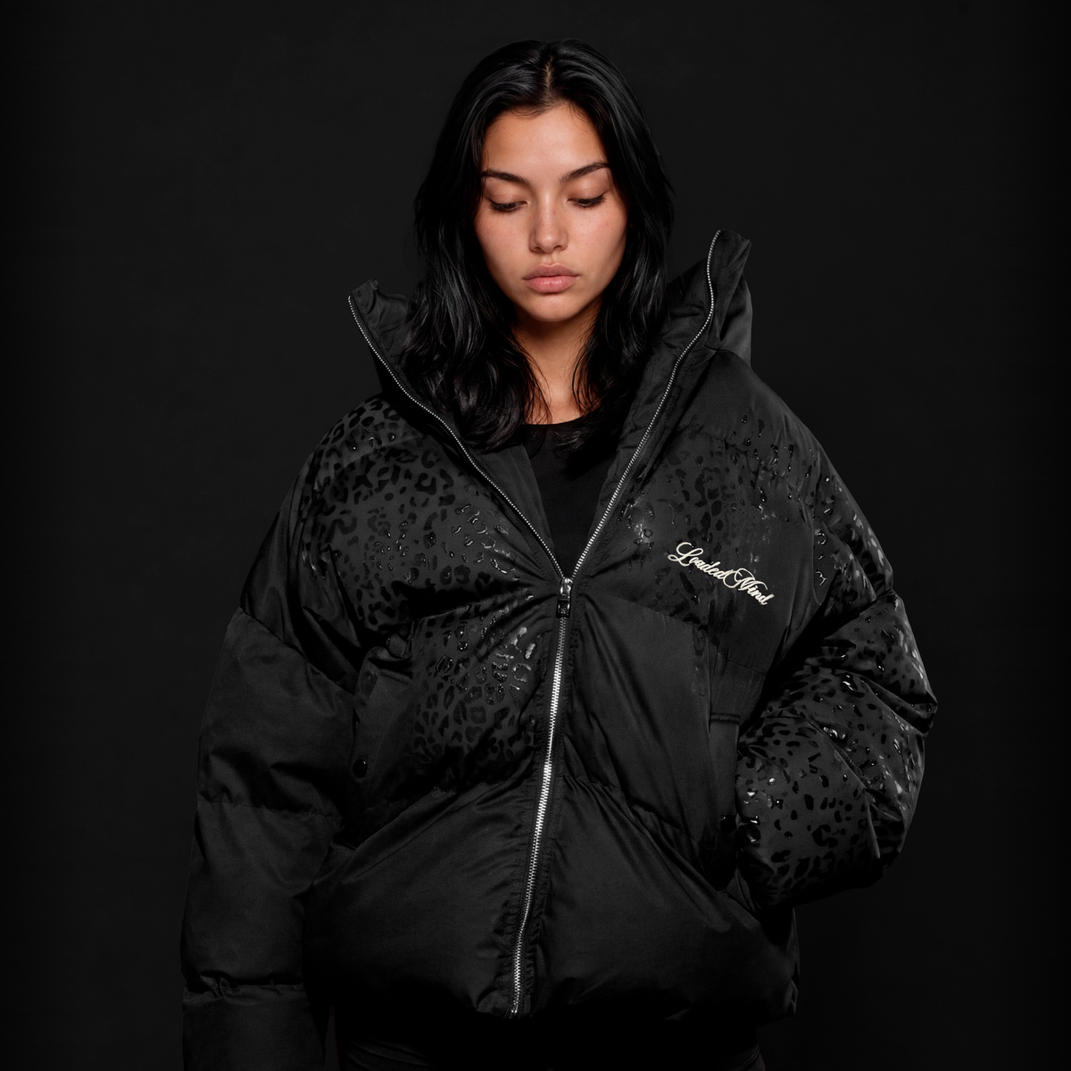 Black leopard reveal puffer in the studio, water beaded across the shoulders