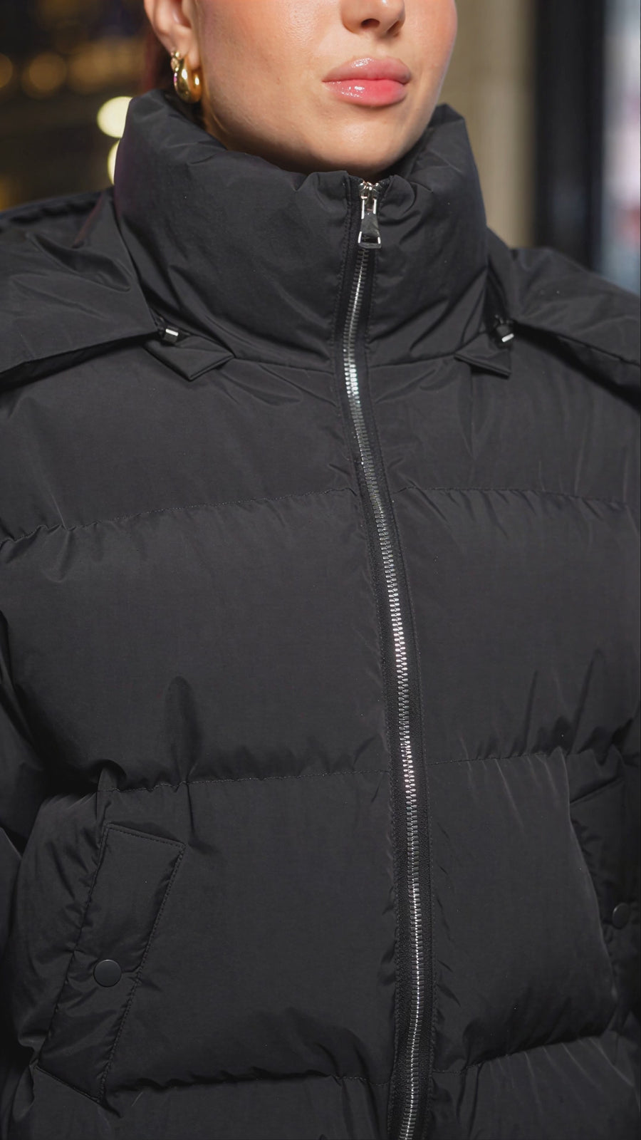 Water from a passing car hits the jacket and the leopard pattern darkens where it landed